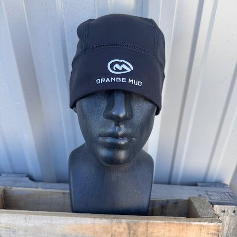 2XL beanie with 'Orange Mud' logo on a mannequin head against a corrugated metal background