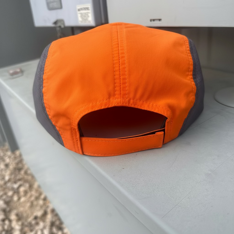 Orange and gray bag on a metal surface
