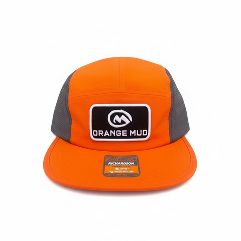 Orange cap with 'Orange Mud' logo on a orange and gray surface
