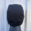 Black hooded garment on a mannequin against a white background