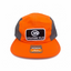 Orange cap with 'Orange Mud' logo on a orange and gray surface