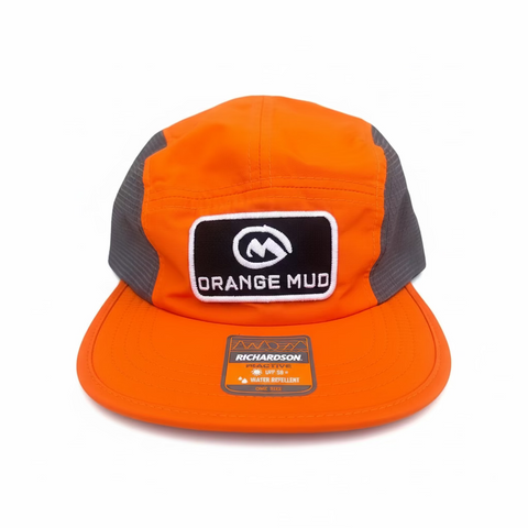Orange cap with 'Orange Mud' logo on a orange and gray surface